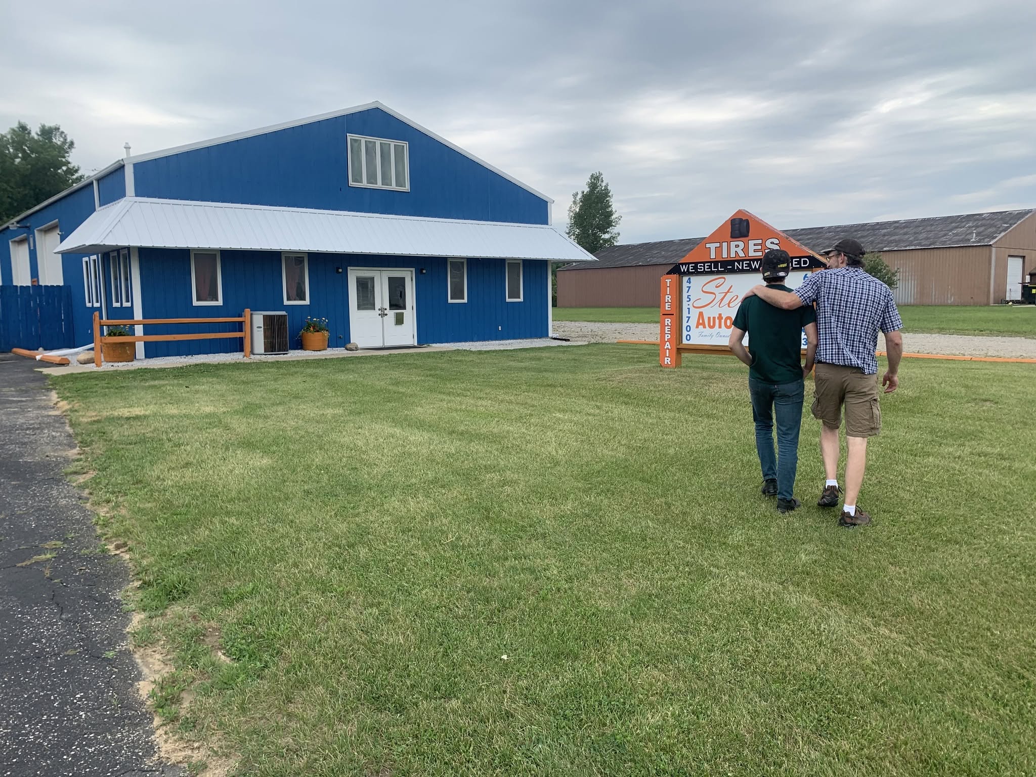 Steuben Automotive's blue barn-style shop building with tire sign out front